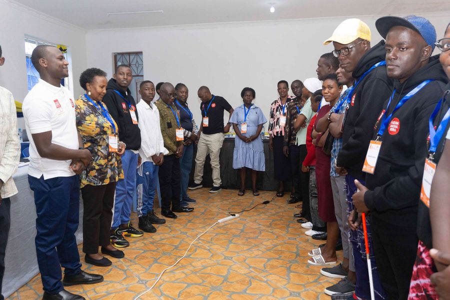 Partners and participants standing in a circle at a Kazi na Maisha Bora workshop